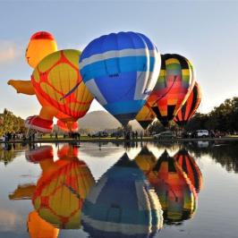 a boat floating along a river next to a body of water