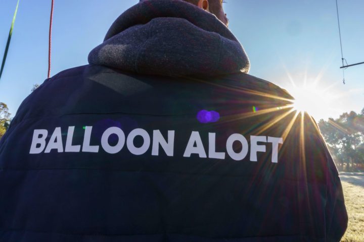 a person with a sunset in the background