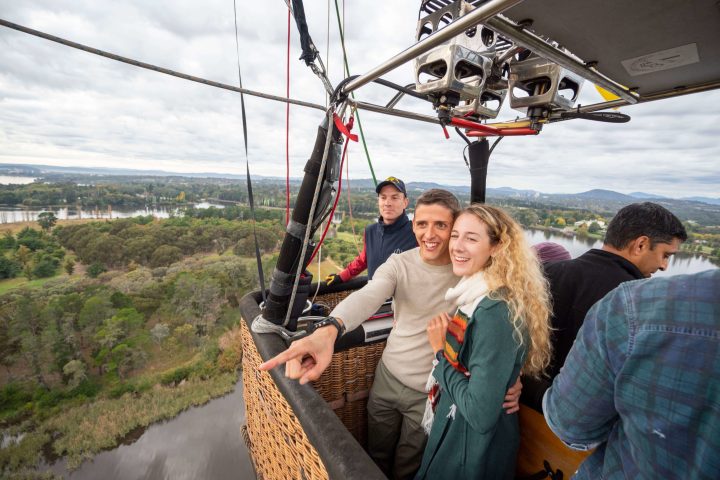 a man and a woman standing on a boat